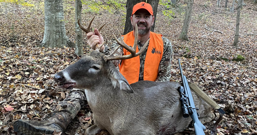 Photo of an Alabama landowner with a buck from hunting their own property.
