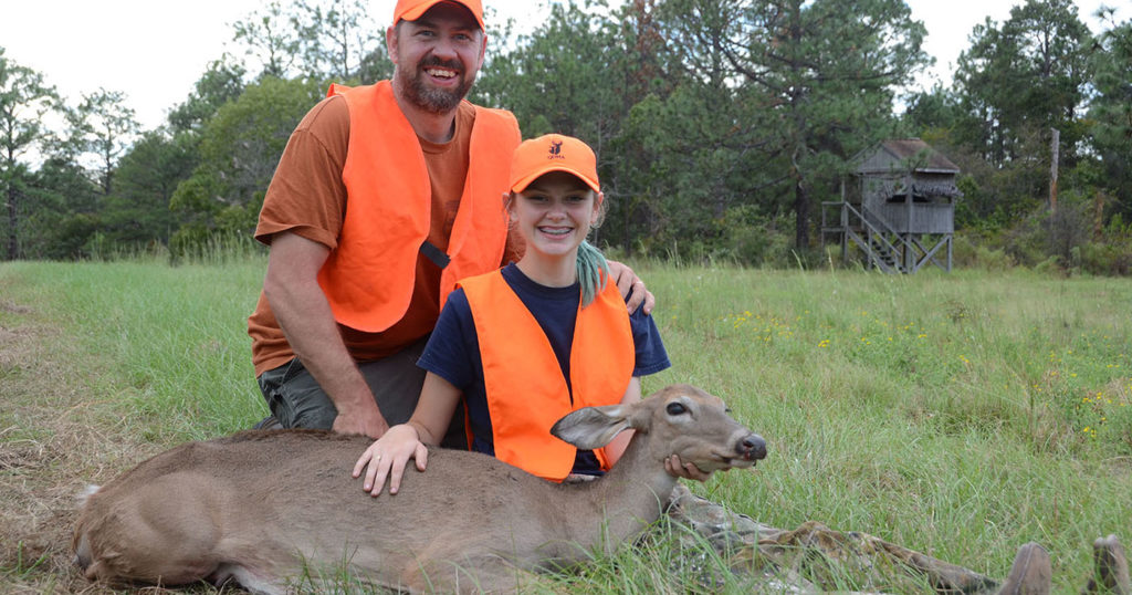 Photo of a youth hunter and her dad with a deer.