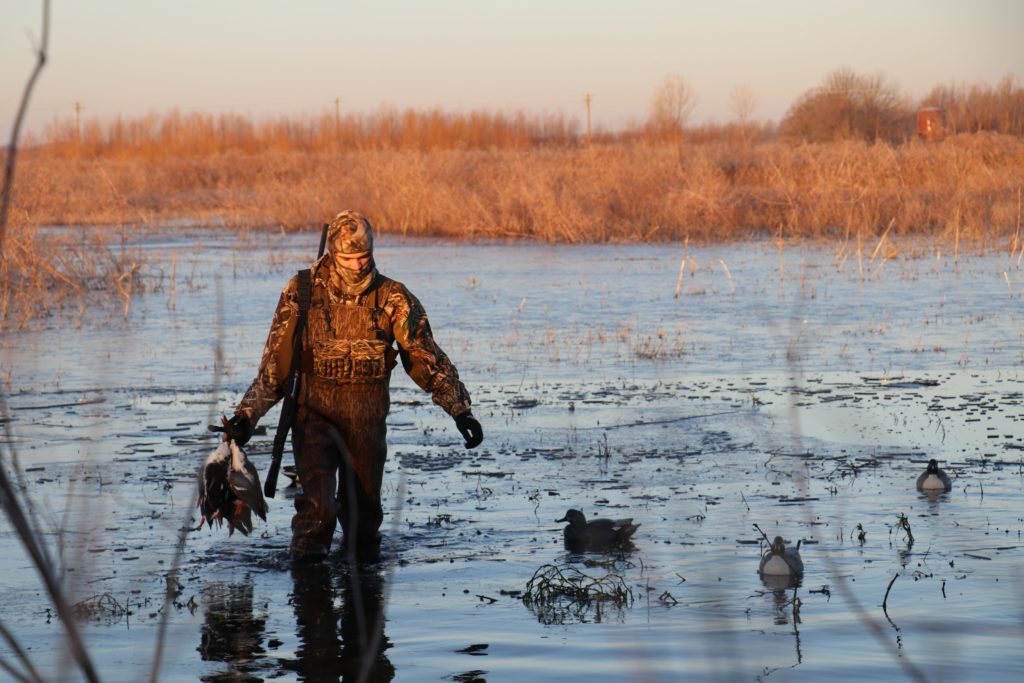 Photo of a Mississippi youth waterfowl hunter putting out decoys.
